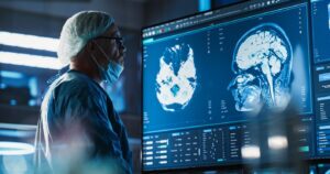 Doctor looking at medical images on a large screen