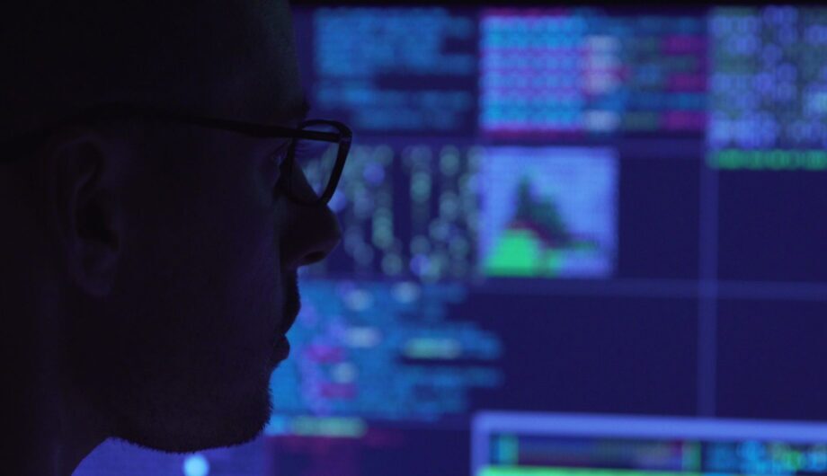 Pulse 360 AV monitoring and management - man in dark room monitoring AV equipment remotely.