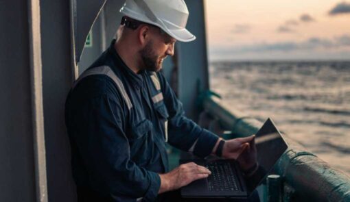 Audiovisual managed service worker on a laptop on an oil rig