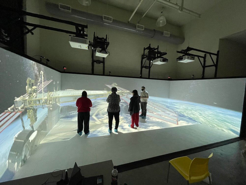 SUBR CAVE with 4 people standing in it