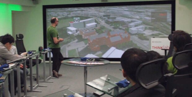 Large group of engineering students looking at Mechdyne powerwall