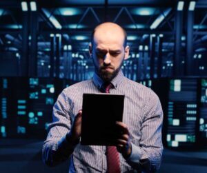 IT employee managing data on an iPad