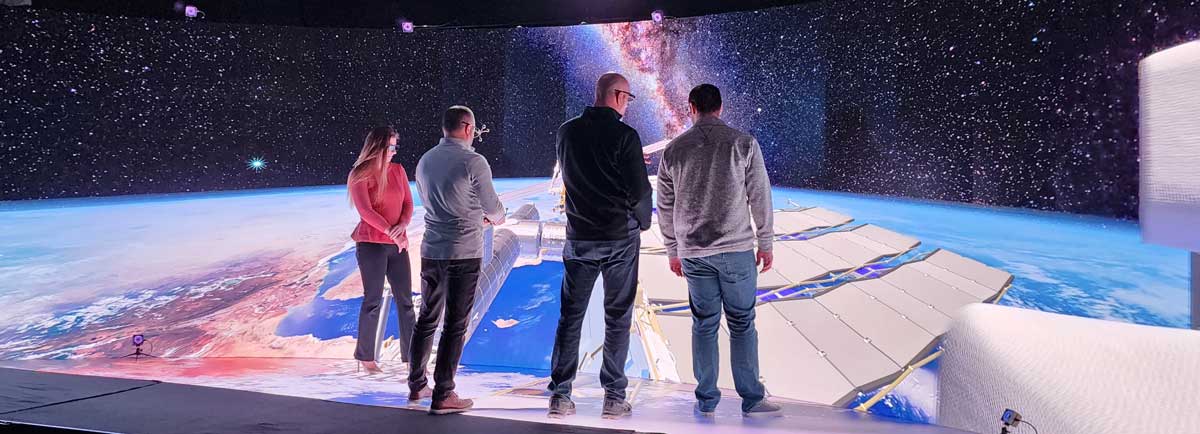 3D Group - people standing in front of a data visualization screen