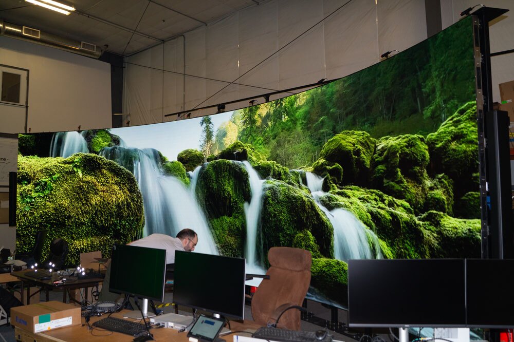 Curved LED powerwall with green waterfall graphic
