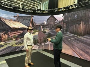 Two men standing in a large scale VR space