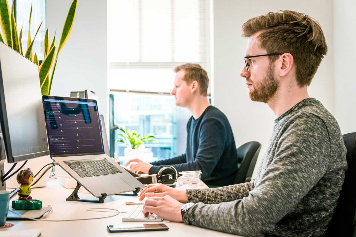 two people working in front of computers