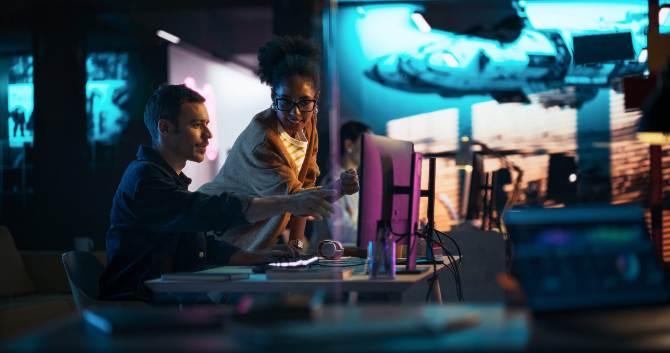 Portrait of Black Creative Director Giving Instructions on 3D Game Visuals to Male Developer in Creative Agency. Two Stylish Diverse Employees Discussing Design on Computer in Game Development Company
