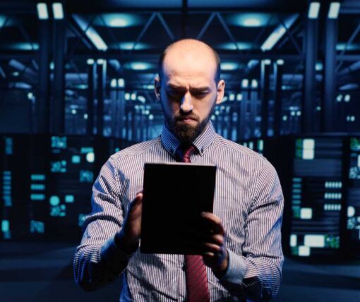 IT employee managing data on an iPad