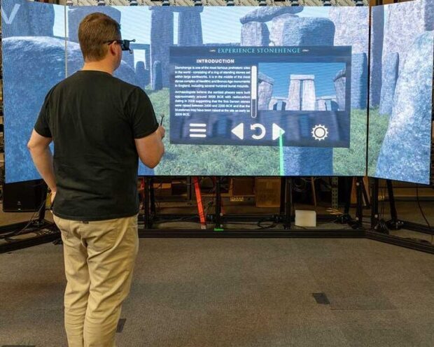 Man using Experience Stonehenge on visualization screen in staging