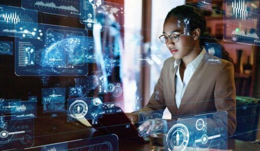 Woman in tan suit working on remote AV monitoring